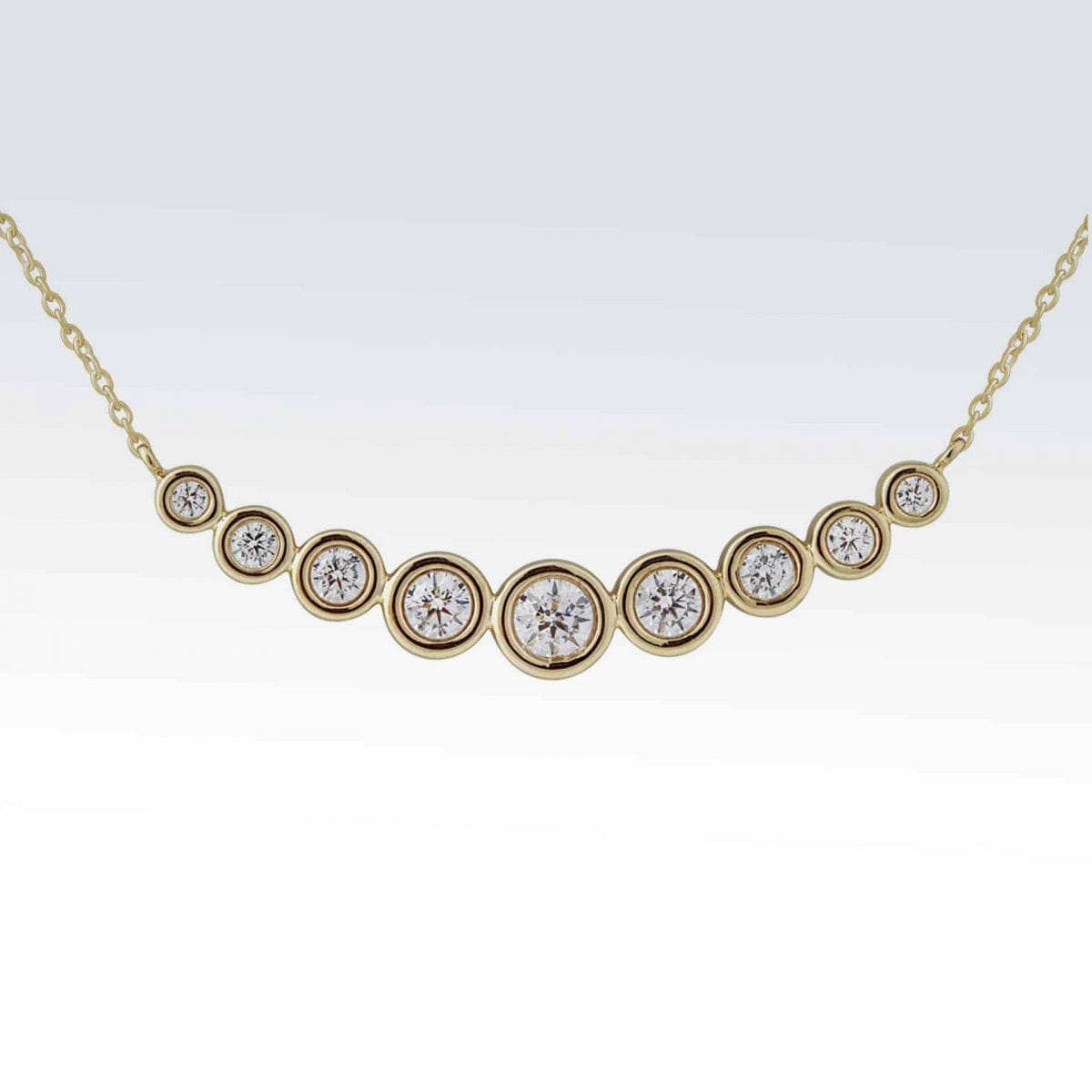 14 karat yellow gold necklace with 7 bezel set diamonds