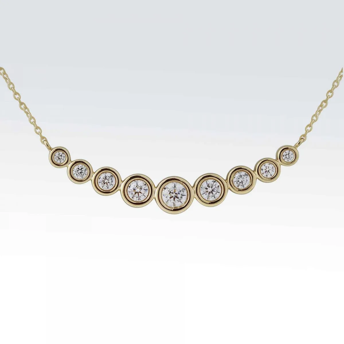 14 karat yellow gold necklace with 7 bezel set diamonds